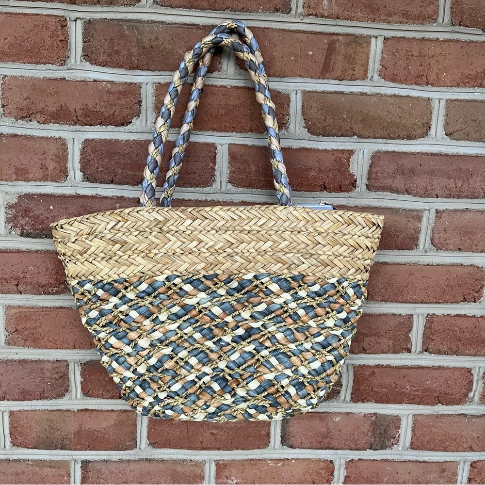 Beachy straw woven tote bag with zip top. Designer: Sun N Sand